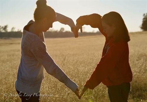 People forming a heart with arms and hands